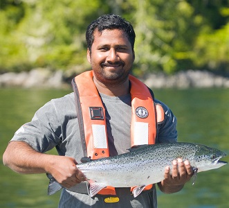 Employee holding salmon